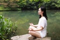 A happy free smile peace balance meditation beauty girl Asian Chinese travel hiking smell maple do yoga by lake bag hangzhou xihu Royalty Free Stock Photo