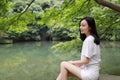 A happy free smile peace balance meditation beauty girl Asian Chinese travel hiking smell maple do yoga by lake bag hangzhou xihu Royalty Free Stock Photo