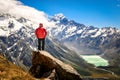 Happy free tourist man standing outstretched up looking at river and mountains landscape from Mueller Hut, MT. Cook - New Zealand Royalty Free Stock Photo