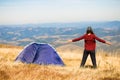 Happy freedom girl with hands up in mountains camping travel Royalty Free Stock Photo