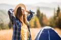 Happy freedom girl in straw hat with hands up in mountains travel Royalty Free Stock Photo