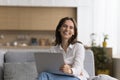 Happy freelance business woman holding laptop, sitting on couch Royalty Free Stock Photo