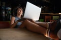 Happy freelance woman using laptop at cafe for work. Young beautiful girl sitting in a coffee shop and working on computer online Royalty Free Stock Photo