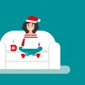 Happy freelancer girl with santa hat on sofa with laptop. creative hipster work at home.