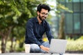 happy freelancer indian man working with laptop pc computer outdoors Royalty Free Stock Photo