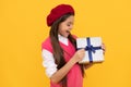 happy french teen girl open present box. childhood happiness. boxing day. cheerful kid in beret.