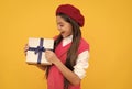 happy french teen girl open present box. childhood happiness. boxing day. cheerful kid in beret.