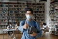 Happy fresh college student covering breathing organs with facial mask Royalty Free Stock Photo