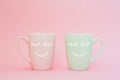 Happy friday word. Two cups of coffee stand together to be heart shape on pink background with smile face on cup. Royalty Free Stock Photo