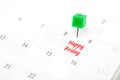 Happy friday written on a calendar with a green push pin to remind you and important appointment Royalty Free Stock Photo