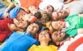 Happy friend group lying on meadow after world soccer event - Fr