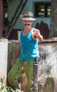 Happy and friendly Cuban senior farmer and groom man capture portrait in old poor valley, Cuba, America.