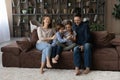 Happy friendly family using smartphone at home. Royalty Free Stock Photo