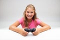 Happy friendly little girl holding a playstation