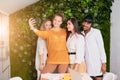 Happy friendly multi-ethnic team of businesswomen posing at smartphone camera Royalty Free Stock Photo