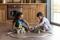 Happy friendly small boy girl playing toys in kitchen. Royalty Free Stock Photo