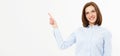 Happy friendly woman points hand on white background Royalty Free Stock Photo