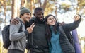 Happy friends backpackers taking selfie on smartphone Royalty Free Stock Photo