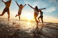 Happy friends at beach party runs to sunset water Royalty Free Stock Photo