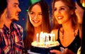 Happy friends birthday party with candle celebration cakes in club. Royalty Free Stock Photo