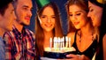 Happy friends birthday party with candle celebration cakes in club. Royalty Free Stock Photo