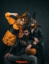 Happy friends celebrating Halloween. Close up Halloween portrait of funny group. Surprised group of friends in witch hat