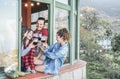 Happy friends cheering with red wine at dinner in patio terrace - Adult people having fun together in mountain vineyard farm - Royalty Free Stock Photo