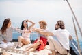 Happy friends clinking glasses of champagne and sailing on yacht Royalty Free Stock Photo