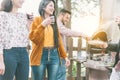 Happy friends cooking meat and vegetables at barbecue dinner outdoor - Young people drinking red wine for bbq in garden backyard Royalty Free Stock Photo