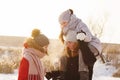 Group of teenage friends having fun snow in winter Royalty Free Stock Photo