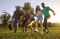 Happy friends dancing and laughing outdoor. Joyful young people having fun and being silly on weekend in countryside Royalty Free Stock Photo