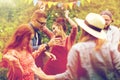 Happy friends dancing at summer party in garden Royalty Free Stock Photo