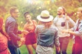 Happy friends dancing at summer party in garden Royalty Free Stock Photo