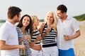 Happy friends drinking non alcoholic beer on beach