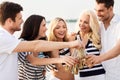 Happy friends drinking non alcoholic beer on beach