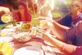 Happy friends with drinks at summer garden party Royalty Free Stock Photo