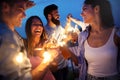 Happy friends with drinks toasting at rooftop party at night