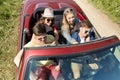 Happy friends driving in cabriolet car at country Royalty Free Stock Photo