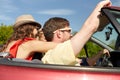 Happy friends driving in cabriolet car at country Royalty Free Stock Photo