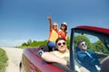 Happy friends driving in cabriolet car at country Royalty Free Stock Photo