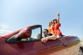 Happy friends driving in cabriolet car at country Royalty Free Stock Photo