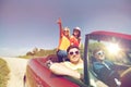 Happy friends driving in cabriolet car at country Royalty Free Stock Photo