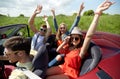 Happy friends driving in cabriolet car at country Royalty Free Stock Photo