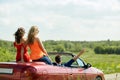 Happy friends driving in cabriolet car at country Royalty Free Stock Photo