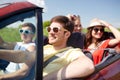 Happy friends driving in cabriolet car Royalty Free Stock Photo