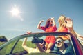 Happy friends driving in cabriolet car Royalty Free Stock Photo