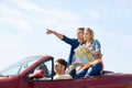 Happy friends driving in cabriolet car Royalty Free Stock Photo