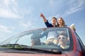 Happy friends driving in cabriolet car Royalty Free Stock Photo
