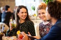 Happy friends eating and drinking at restaurant Royalty Free Stock Photo