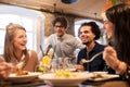 Happy friends eating and drinking at restaurant Royalty Free Stock Photo